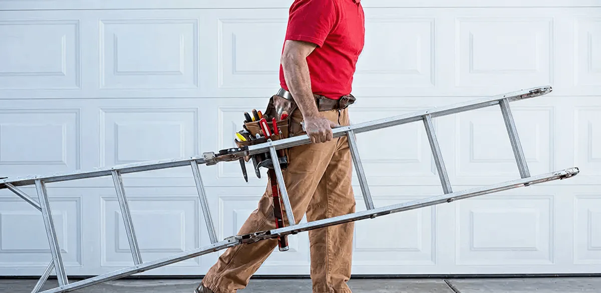 Garage door repair technician arriving with tools and ladder in Mobile, AL
