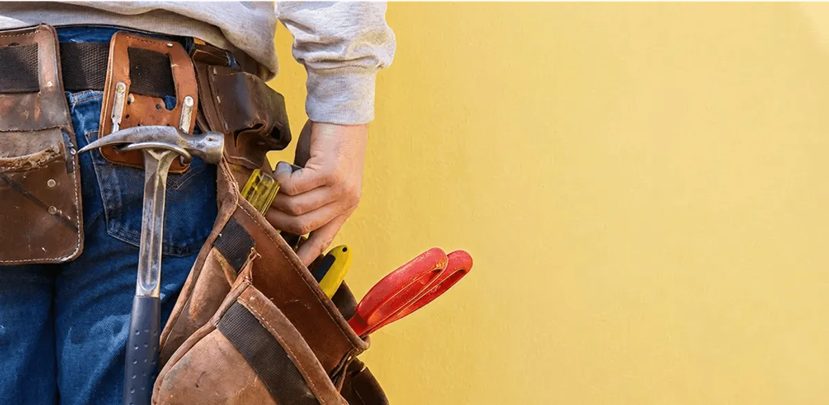 Handyman with tool belt ready for home repairs and maintenance in Mobile, AL